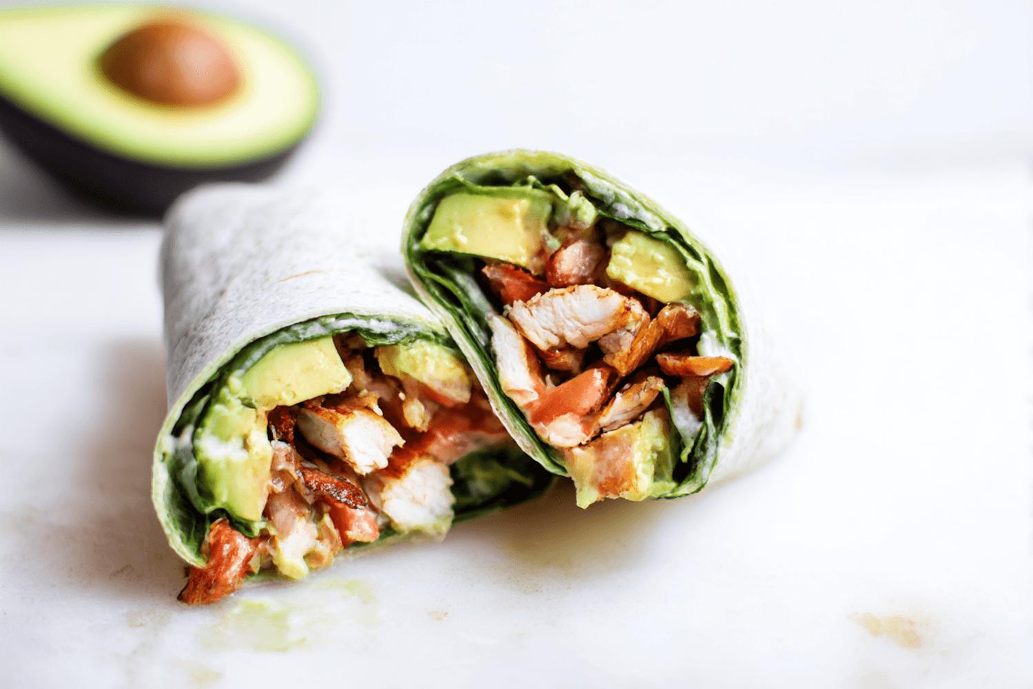 Chicken shawarma wrap cut in half showing grilled chicken and fresh greens