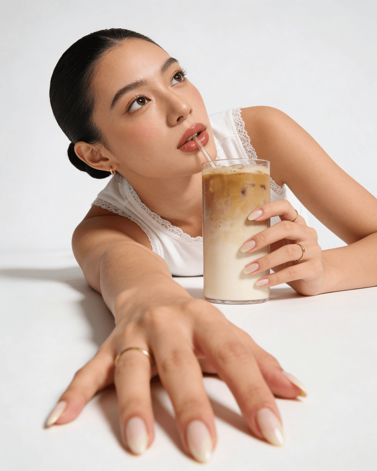 Woman sipping an iced coffee
